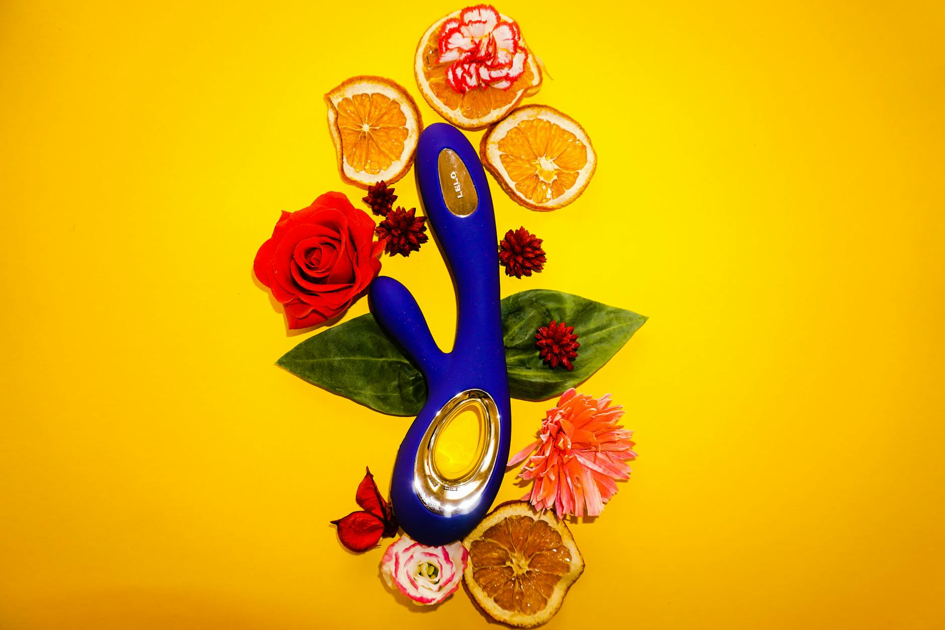 A blue silicone clitoral vibrator held in hand, demonstrating modern air-suction design versus traditional vibration